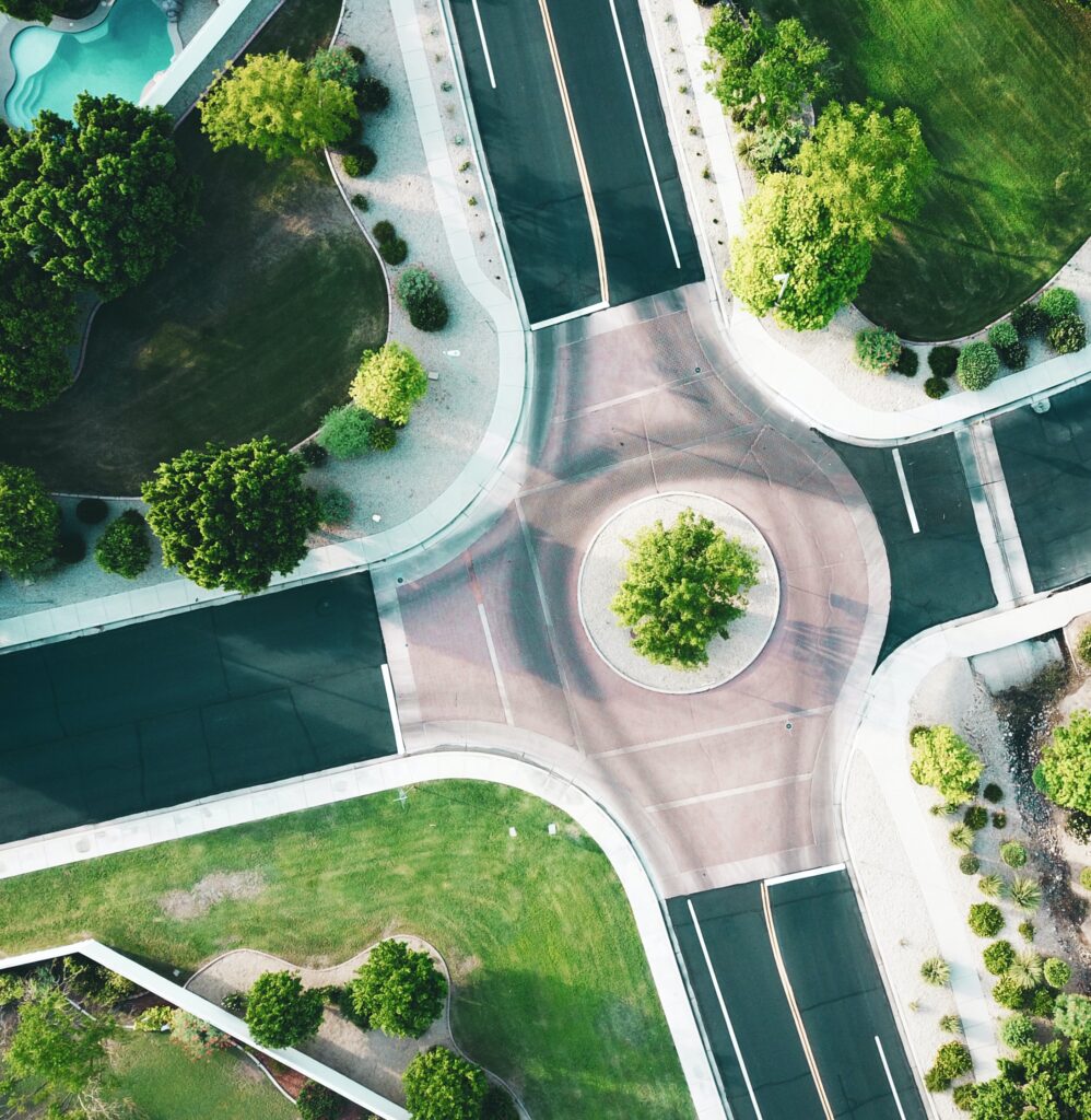 Overhead view of a traffic round-about with green space in the center.
