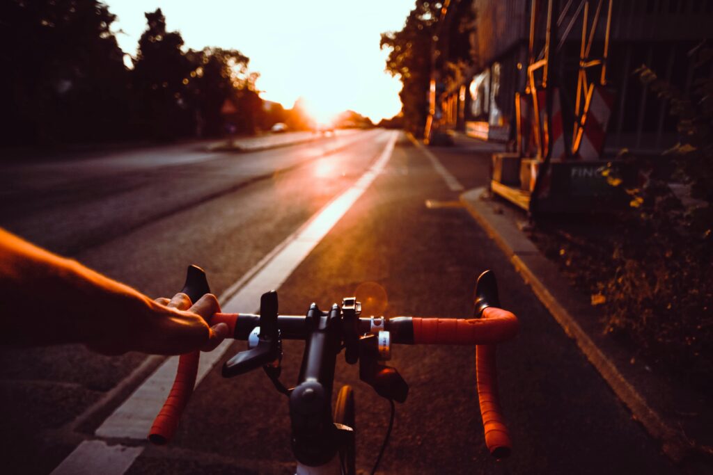 looking down road and bike path over bicycle handles